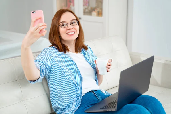 woman doing selfie at work on computer