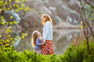 Anne ve kızı kıyıda duruyor..