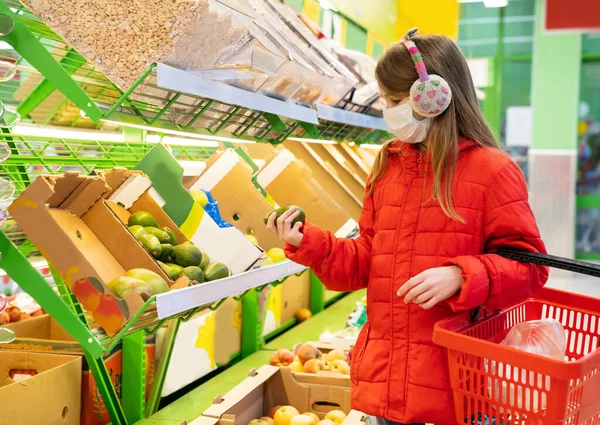girl in red jacket, mask picks fruit vegetables.