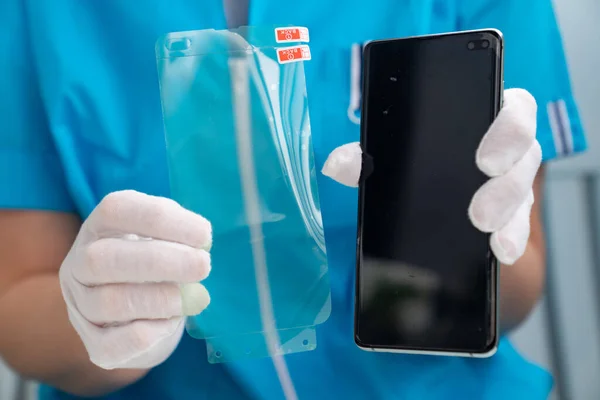 installation of protective cover film smartphone.