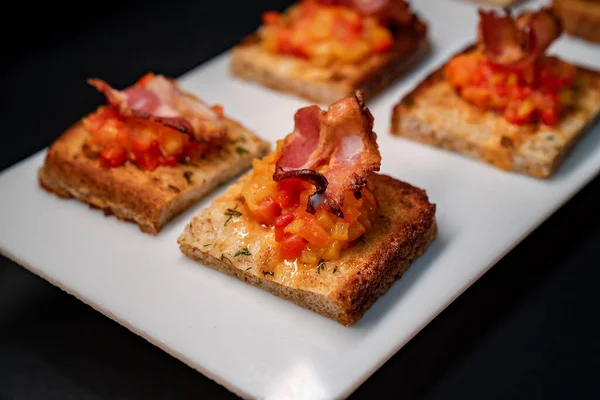 toast with vegetables and bacon, close up