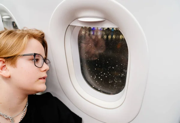 El temblor del avión y el niño cierra la ventana — Foto de Stock