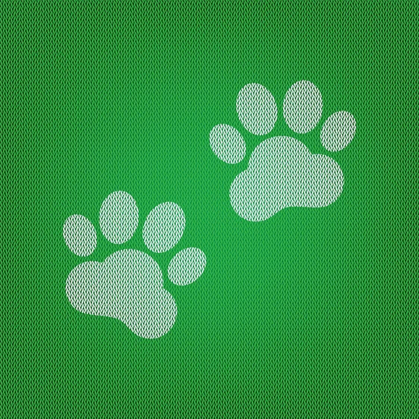 Знак "Следы животных". белая иконка на зеленом трикотаже или шерстяном с — стоковый вектор
