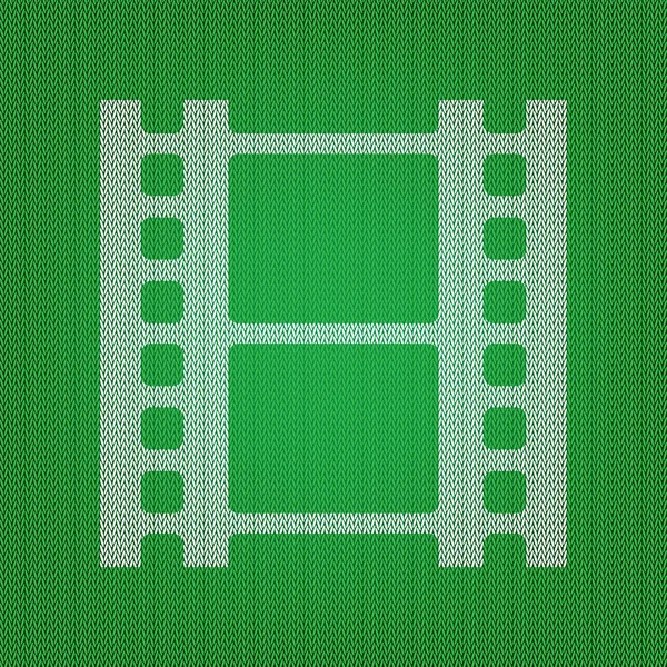 Rolle des Filmzeichens. weißes Symbol auf der grünen Strick- oder Wolljacke — Stockvektor