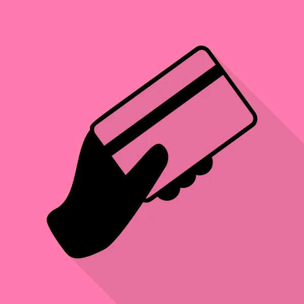 Χέρι που κρατά μια πιστωτική κάρτα. Μαύρο εικονίδιο με επίπεδη στυλ σκιάς διαδρομή σε ροζ φόντο. — Διανυσματικό Αρχείο