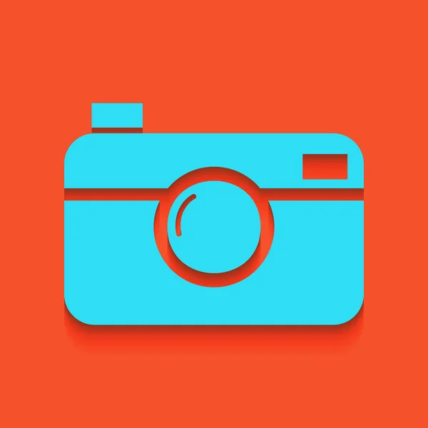 Digital photo camera sign. Vector. Blue icon with soft shadow putted down on flamingo background. — Stock Vector