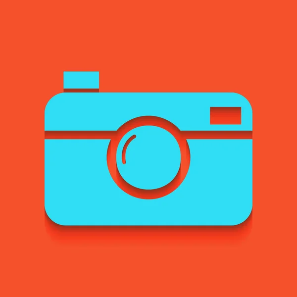 Signo de cámara fotográfica digital. Vector. Icono azul con sombra suave sobre fondo flamenco . — Archivo Imágenes Vectoriales