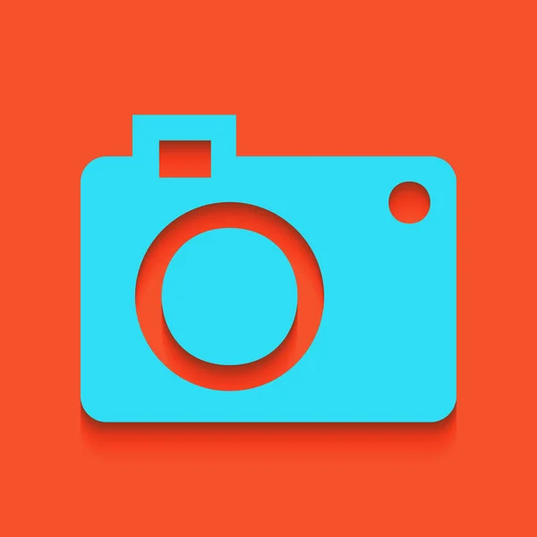 Signe de caméra numérique. Vecteur. Icône bleue avec ombre douce posée sur fond de flamant rose . — Image vectorielle
