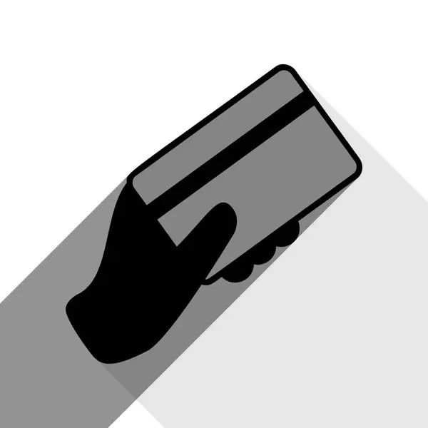 Hand hält eine Kreditkarte. Vektor. schwarzes Symbol mit zwei flachen grauen Schatten auf weißem Hintergrund. — Stockvektor
