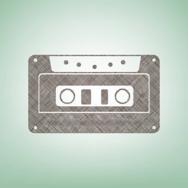 Kaset simgesi, ses bandı işareti. Vektör. Işık spot Merkezi yeşil zemin üzerine kahverengi keten simgesi.