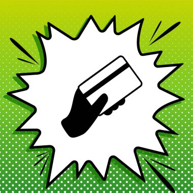 Kredi kartı tutuyor. Beyaz popart üzerine siyah simge Yeşil arka planda beyaz benekli sıçrama.