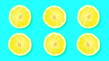 Looping animation with lemon. Several slices of citrus rotate against a blue background.