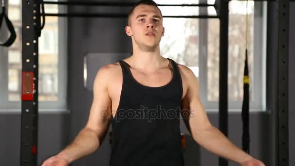 Close up shot of an athletic man skipping fancily with a jump rope — Stock Video