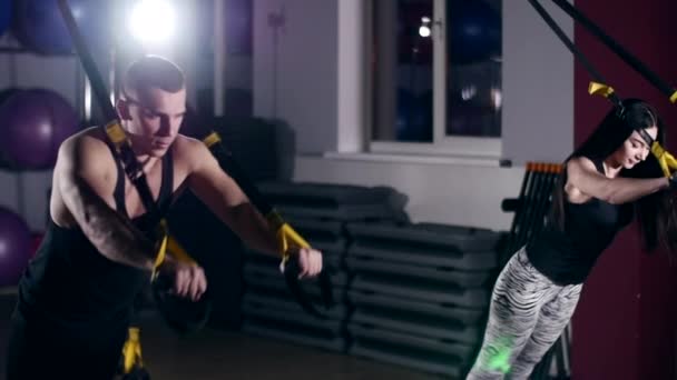 Man is engaged in trx exercises in the studio — Stock Video
