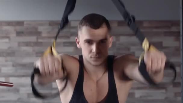 Man exercise at a gym by using bungee training — Stock Video