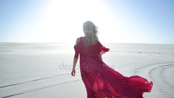 A woman walking on a sand dune during sunrise — Stock Video