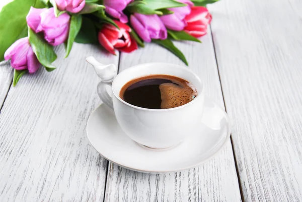 cup of coffee with tulips