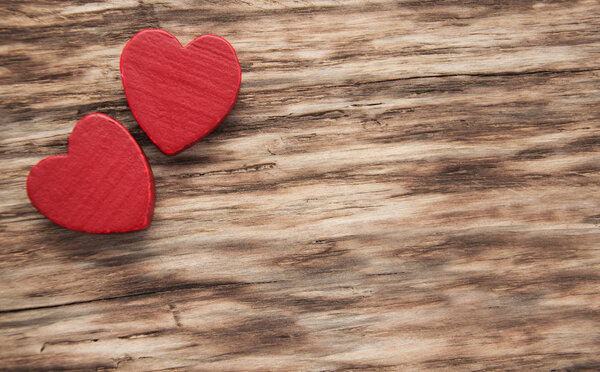 Red hearts on a wooden background