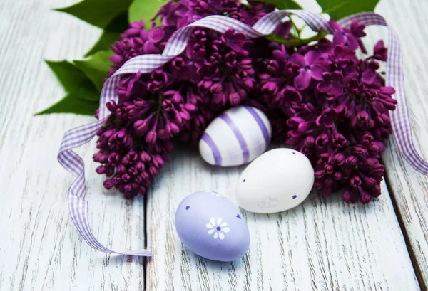 Easter eggs and fresh lilac flowers Stock Picture