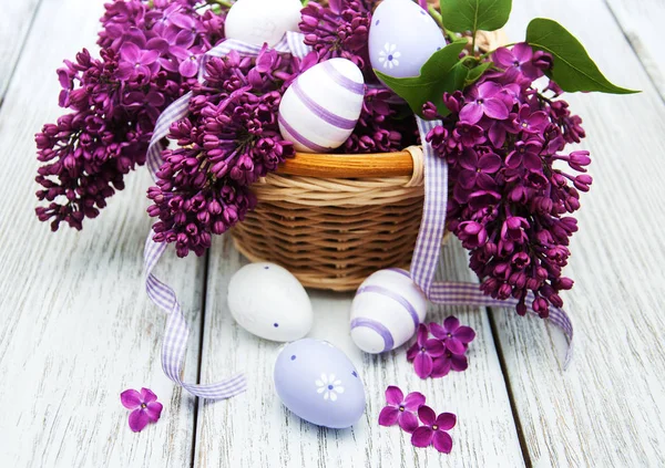 Easter eggs and fresh lilac flowers Stock Image