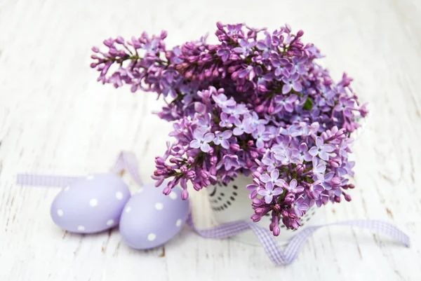 Easter eggs and fresh lilac flowers Stock Image