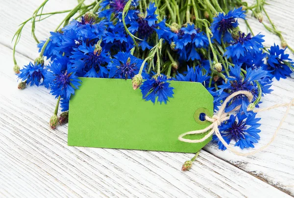 Paper tag with  cornflowers — Stock Photo, Image