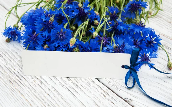 Paper tag with  cornflowers — Stock Photo, Image