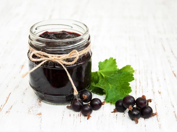 Jar with blackcurrants jam — Stock Photo, Image
