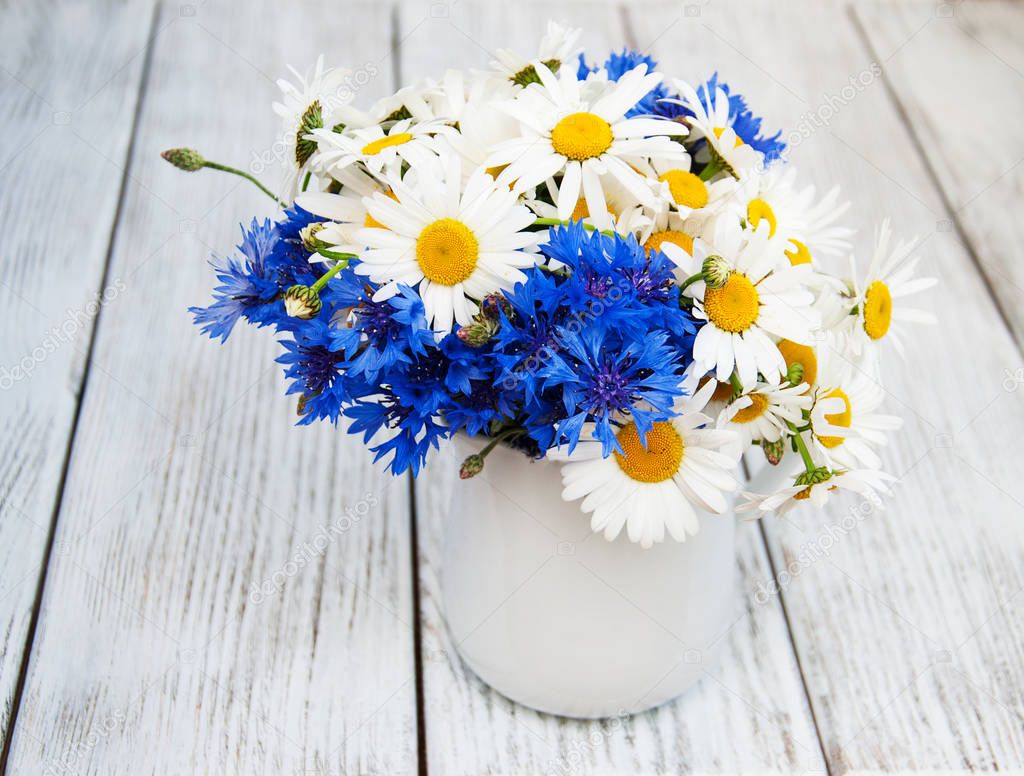 daisies and cornflowers in vase