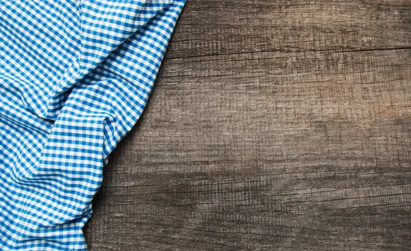 Checkered napkin on a wooden background — Stock Photo, Image