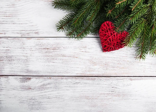 Christmas tree branches with heart decoration — Stock Photo, Image