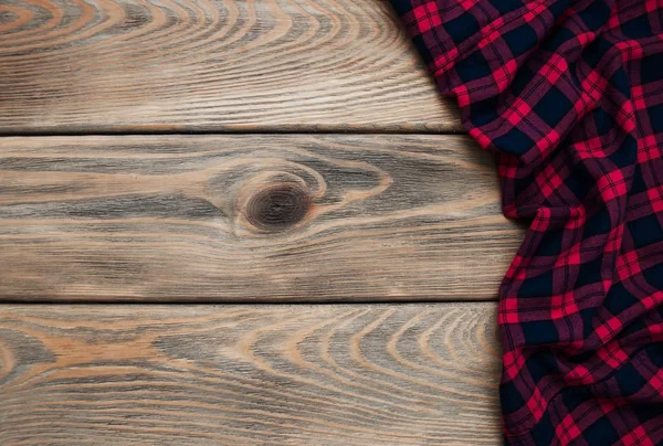 Checkered napkin on a wooden background — Stock Photo, Image