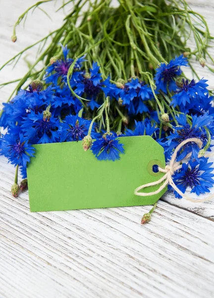 Paper tag with  cornflowers — Stock Photo, Image