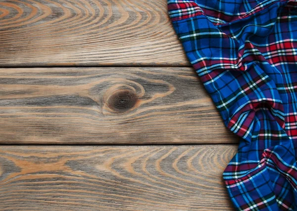 Checkered napkin on a wooden background — Stock Photo, Image