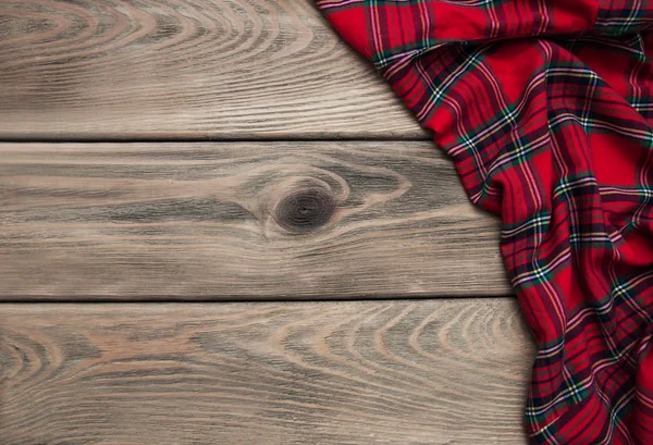 Checkered napkin on a wooden background — Stock Photo, Image