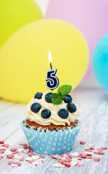 Cupcake with a numeral five candle