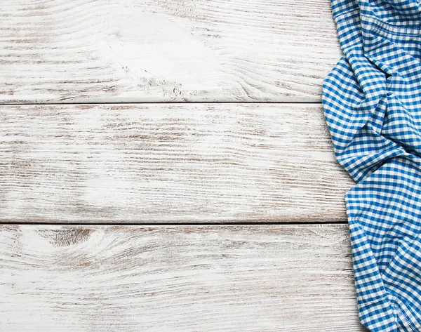 Checkered napkin on a wooden background — Stock Photo, Image