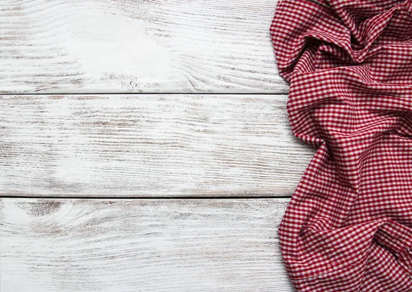 Checkered napkin on a wooden background — Stock Photo, Image