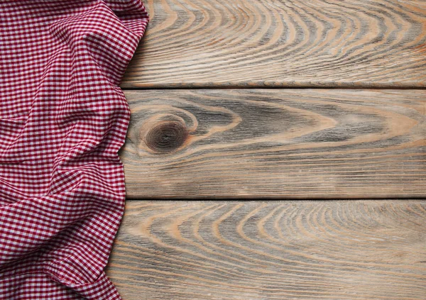 Checkered napkin on a wooden background — Stock Photo, Image