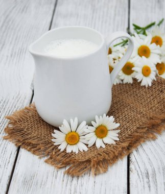 süt ve papatya çiçeği ile sürahi