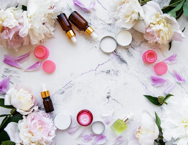 Flat lay composition with peony flowers and natural cosmetic — Stock Photo, Image