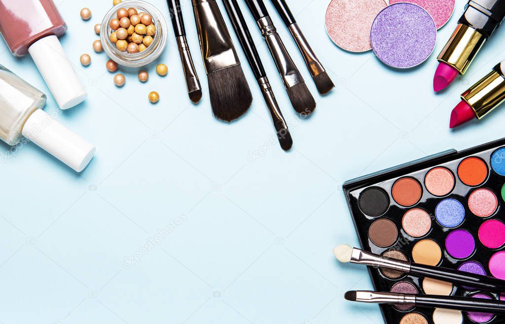 Set of decorative cosmetics on a light blue  background. Flat lay, top view.