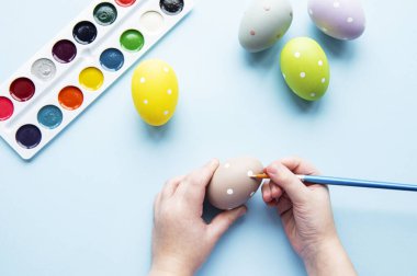 Mutlu Paskalyalar. Paskalya yumurtası boyayan küçük bir kız çocuğu. Paskalya için hazırlanıyorum. Paskalya yumurtası taşıyan bir kızın elleri. yakın plan