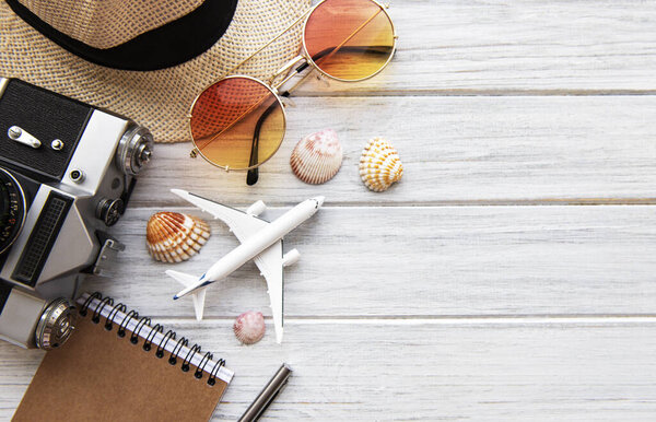 Summer holiday background, travel concept with camera on wooden table background. Flat lay