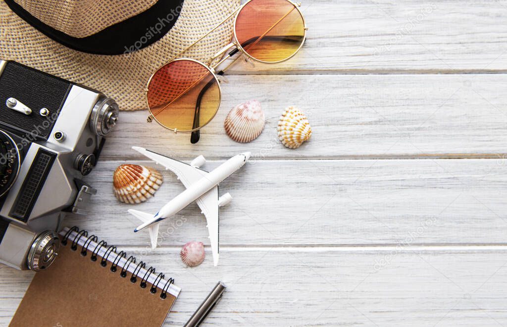 Summer holiday background, travel concept with camera on wooden table background. Flat lay