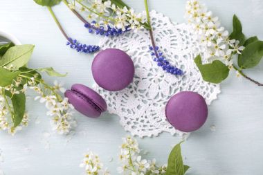 Üç mor bademli kurabiye kurabiye ve masaya çiçek