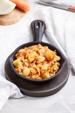 Cabbage stewed with potatoes. Vegetable ragout. Vegan and vegeta