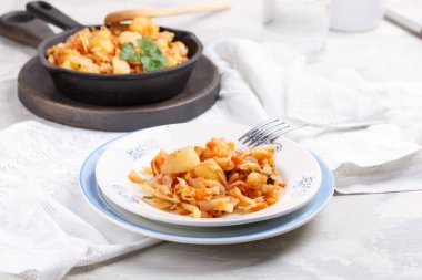 Cabbage stewed with potatoes. Vegetable ragout. Vegan and vegeta