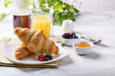 Kahvaltıda kruvasan, kahve, portakal suyu ve böğürtlen var. Boşluğu kopyala. 