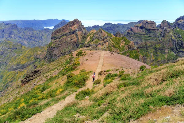 Couple of people walking in the mountains. Mountain landscape. Madeira, Portugal.
